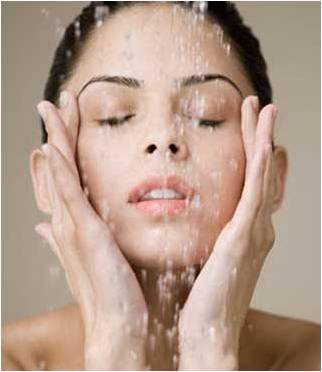 Woman washing her face; using a cleanser